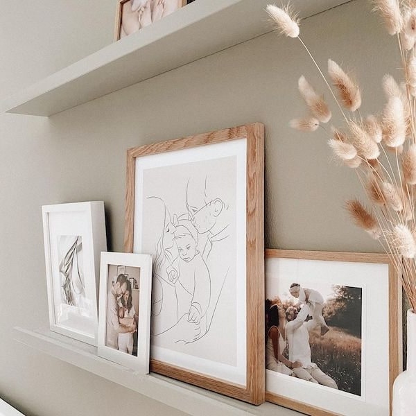 Fotowand met familiefoto's, ertussen een Line Art tekening van een jong gezin, Instagram post van @adriane